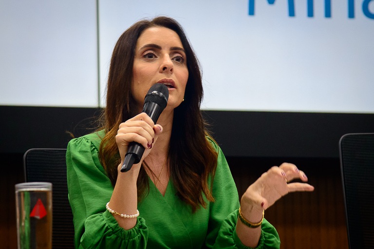 foto da professora da PUC/MG, Maria Cecília Máximo Teodoro, de roupa verde. 